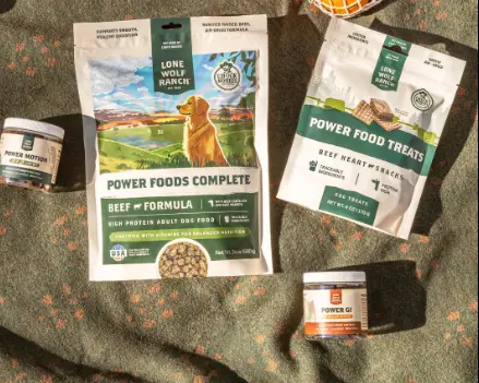 Product arrangement featuring Power Foods Complete Beef Formula, Power Food Treats, and supplements from the lone wolf ranch dog food collection.